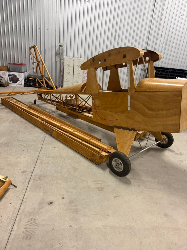 Side view of 1400S Hi-Max Sport fuselage on landing gear with wing spars alongside