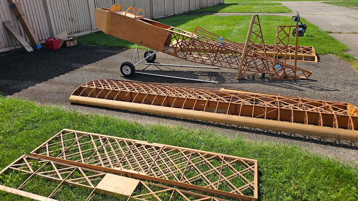 Fisher 303 project wing and tail components beside fuselage