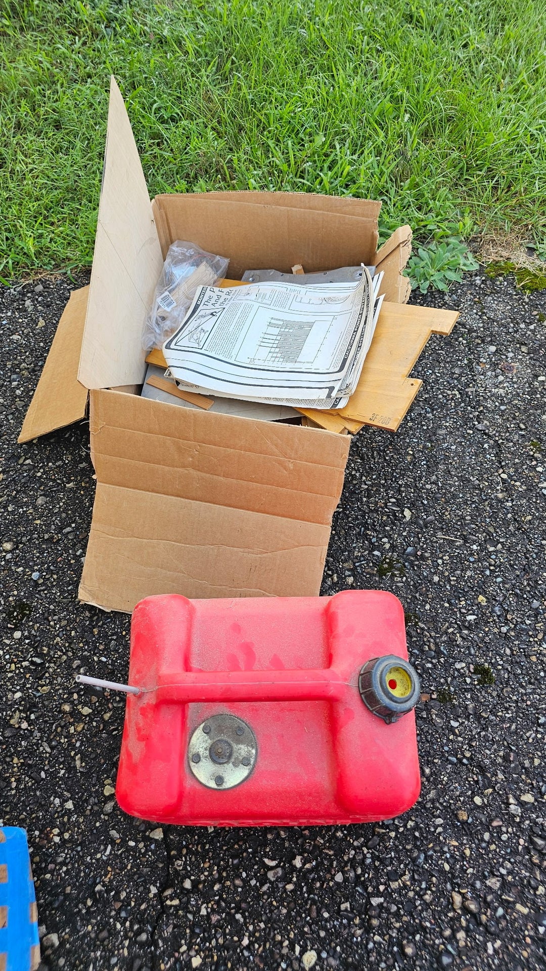 Loose Fisher 303 project parts and papers shown beside a red tank