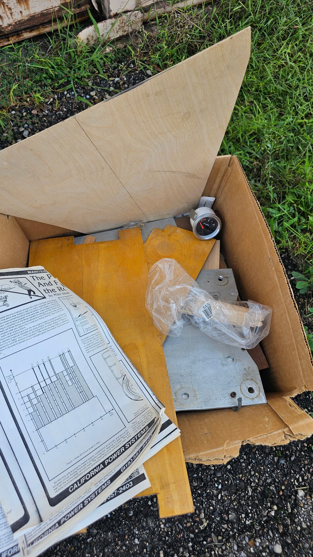 Close view of loose Fisher 303 project components and papers